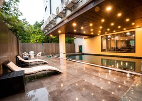 Una piscina al aire libre, tumbonas