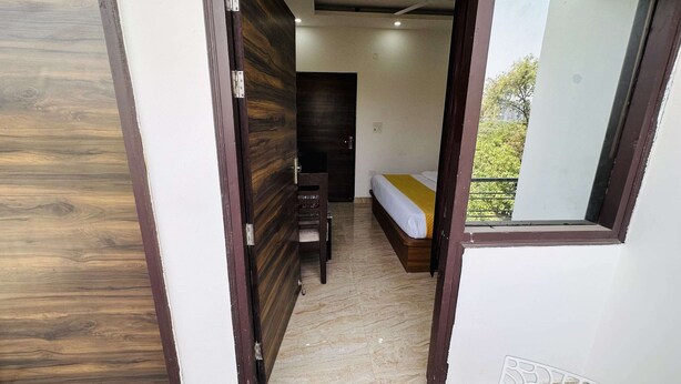 Un dormitorio con cama, escritorio y ventana.
