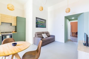 A modern living space with a kitchen, dining area, and seating area.