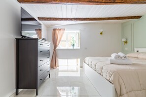 A bedroom with a bed, a dresser, a mirror, a window with curtains, and a light fixture. - Umberto s Nest at Toledo (Naples)
