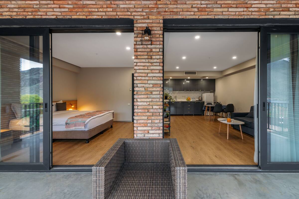 Un apartamento moderno con una cama grande, una cocina y un comedor.