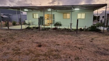 Guests can enjoy a front porch and a fenced yard.