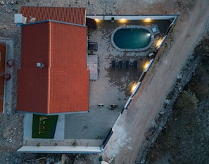 An aerial view of a building with a red roof, a swimming pool, and outdoor seating. - Villa Sea Pearl Zadarvillas (Jasenice)