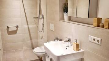 Shower, hair dryer, towels, toilet paper