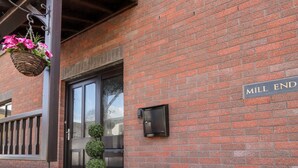A brick building with a sign reading "MILL END". - Mill End (Penrith)