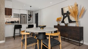 A modern kitchen with a dining area.