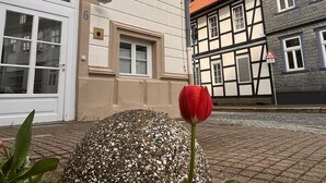 A building with a sign reading "Ritter Rammler" and a cobblestone street. - 2 room apartment in a historic building in the old town of Goslar (Goslar)