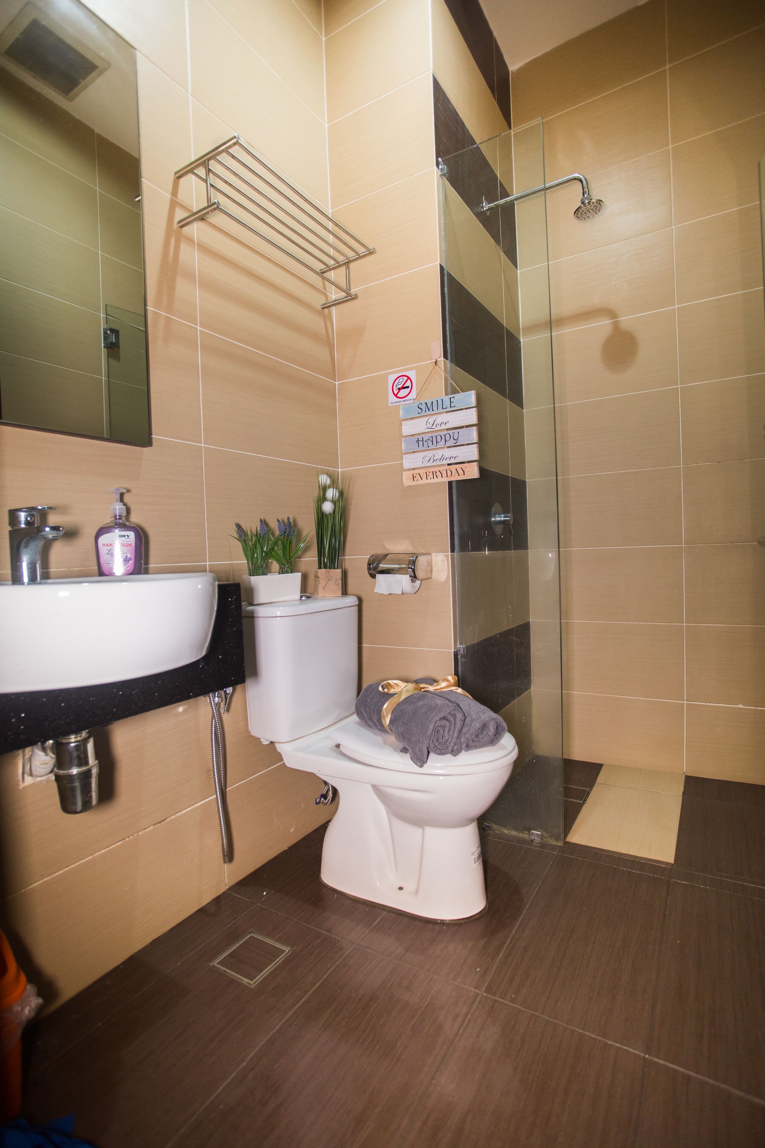 A modern bathroom with a toilet, sink, and shower.