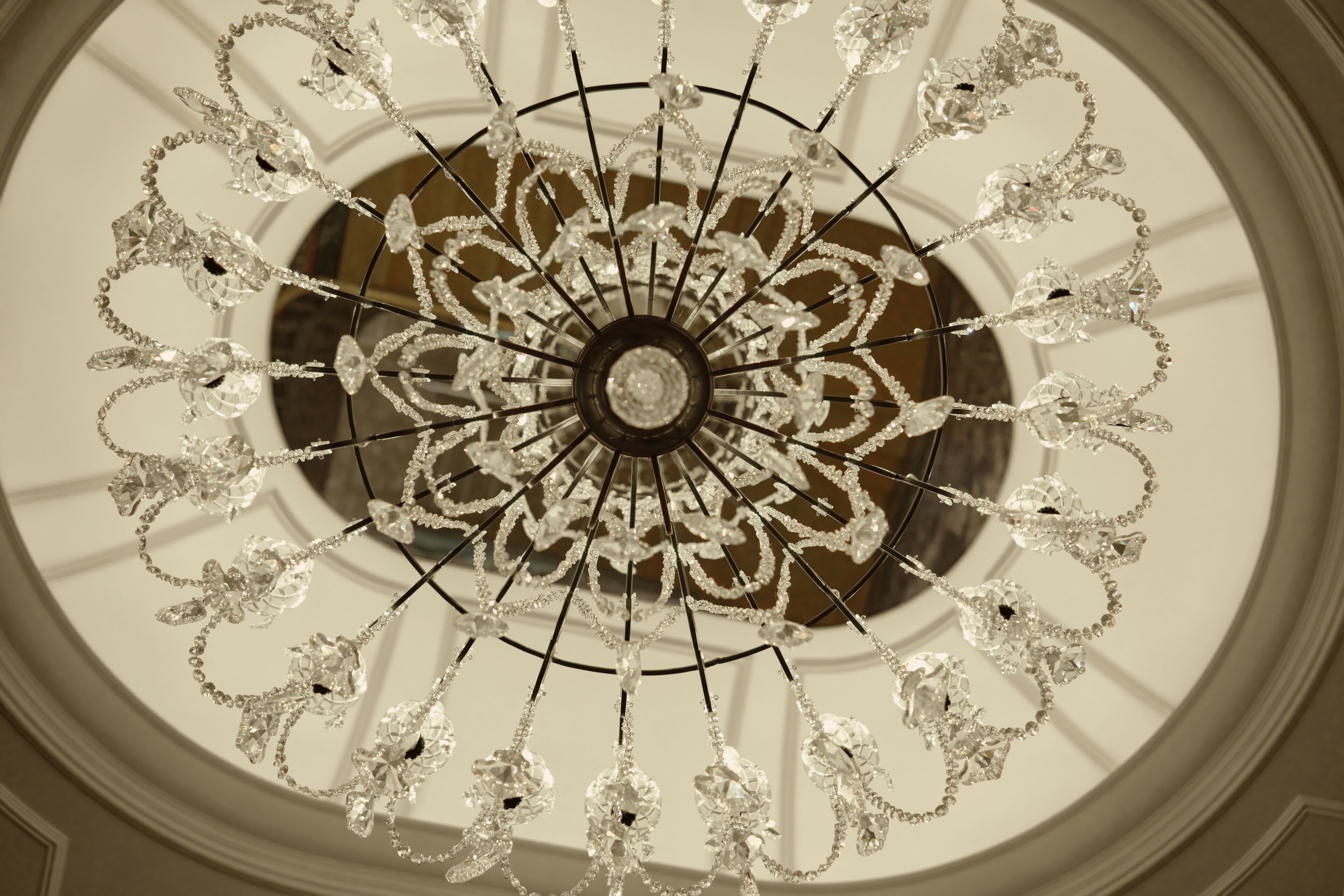 A chandelier with multiple arms and crystal decorations.