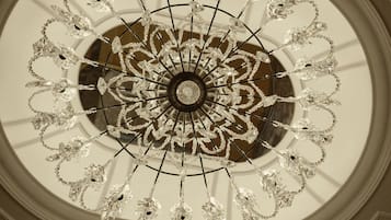 A chandelier with multiple arms and crystal decorations.