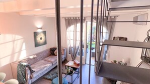 A modern living room with a sofa, coffee table, and a staircase. - Langhe Wine & Relax (Piemonte)