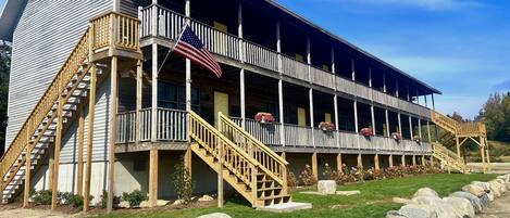 A two-story building with a balcony and a flag.