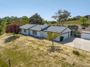 A single-story house with a grey roof, a garage, and a small porch.