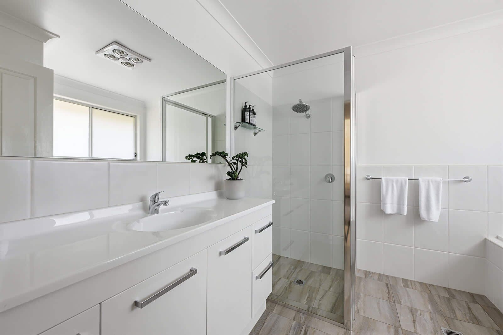 Bathtub, hair dryer, towels, shampoo