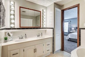 A bathroom with two sinks, a large mirror, and a vanity with cabinets. - Ideal Downtown Family Escape | Walkable | Parking (Lebanon)