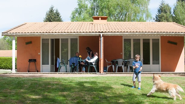 A covered outdoor seating area with a tiled roof, surrounded by a grassy lawn. - Cosy cottage in Sauzé-Vaussais with shared pool (SAUZE-VAUSSAIS)