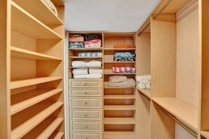 A walk-in closet with multiple shelves and drawers, some containing folded clothes and storage boxes. - Fort Lauderdale Yacht & Beach Club 412 (Fort Lauderdale)