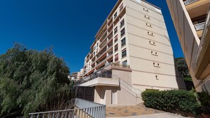 A multi-story residential building with balconies, a central staircase, and a paved courtyard. - Chapelle des Grecs - 1km de la plage (Ajaccio)
