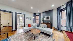 A modern living room with a sectional sofa, a small coffee table, and a pool table. - Pool Table|King Beds|0.6 miles from UofL|Downtown (Louisville)