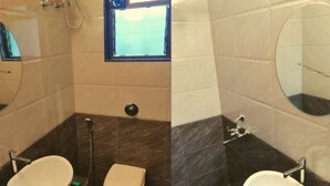 A bathroom with a white sink, a toilet, and a mirror. - Rajdhani Resort Lonavala (Mawal)