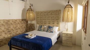 A bedroom with a large bed, a wooden headboard, a bedside table, and a wall-mounted air conditioner.