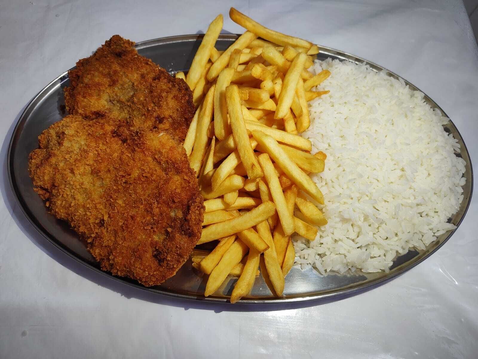 A plate with a breaded cutlet, French fries, and white rice.