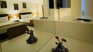 A modern hotel room with a large bed, a desk, a chair, a TV mounted on the wall, and a mirror reflecting the room. - Sirius Otel Pamukkale (Denizli)