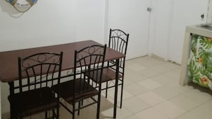 A room with a dining table and chairs, numbered doors, a welcome sign, and a life preserver on the wall. - Downtown  (San Andrés)