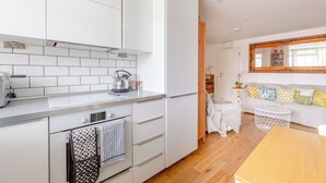 A modern kitchen with white cabinetry, a kettle, and a toaster. - Peaceful Hidden Gem, Heart of South East London (London)