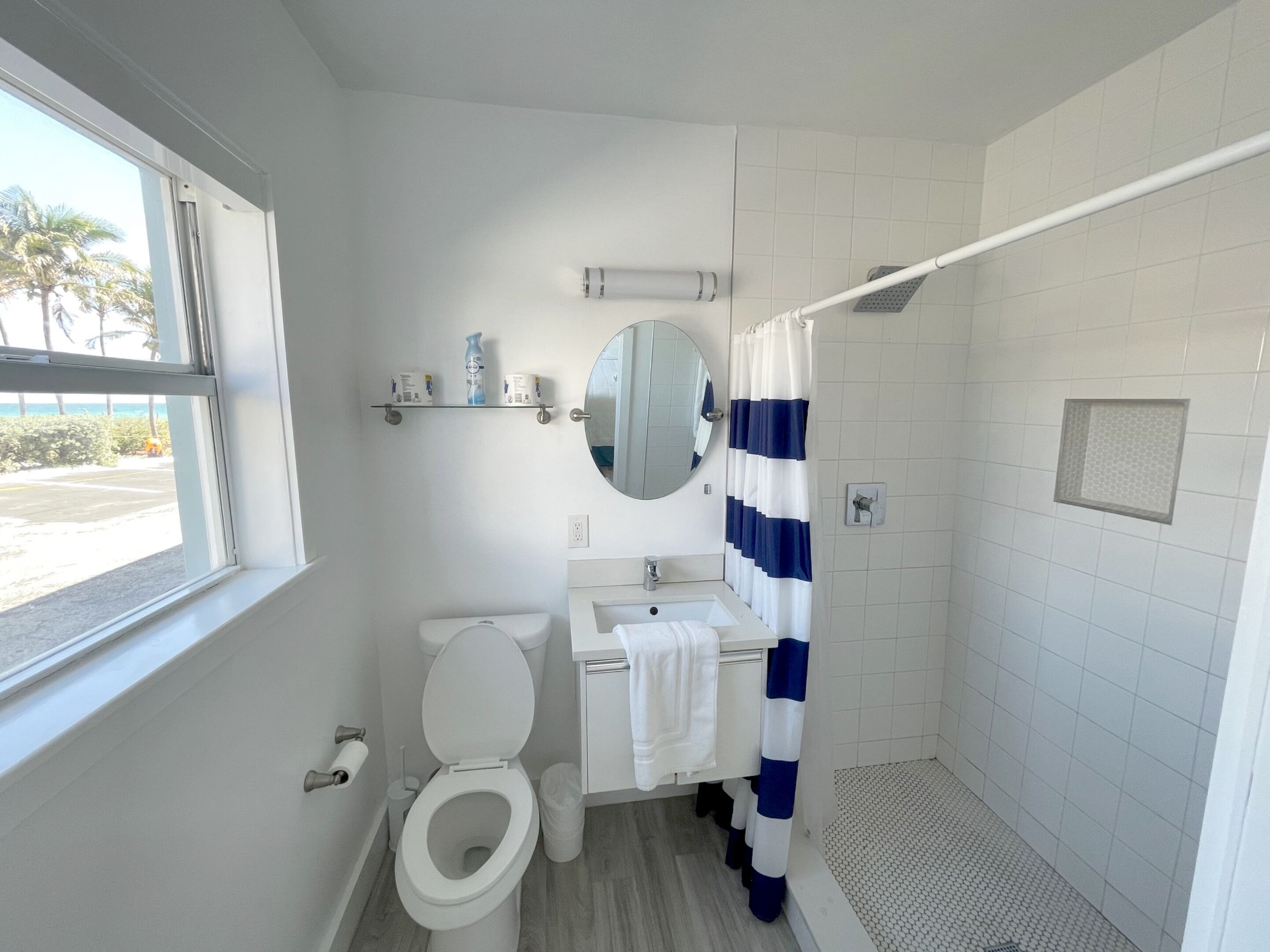 A bathroom with a toilet, sink, and shower.