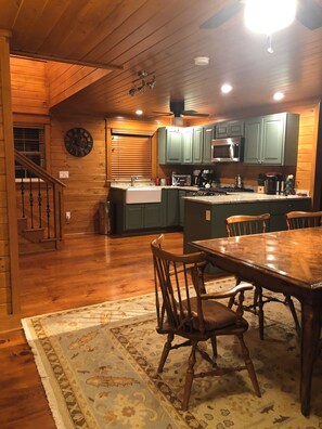 Enjoy meals in this kitchen with a central island, microwave, and range hood above the stove.