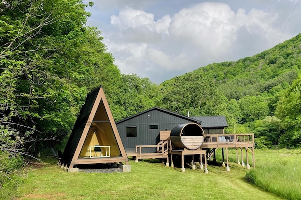 View of home, barrel sauna, A-frame, deck w/hot tub, shower, screened porch