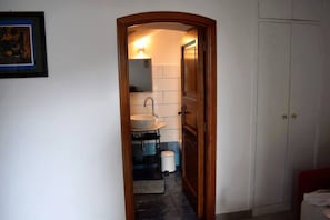 Enter a serene space with a bathroom featuring a sink, mirror, and towel rack.