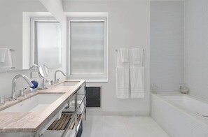 Bathtub, hair dryer, towels, shampoo