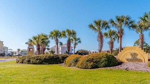 A well-maintained lawn with a stone sign reading "The Breakers." - Seahawk South B by Southern Vacation Rentals (Gulf Shores)