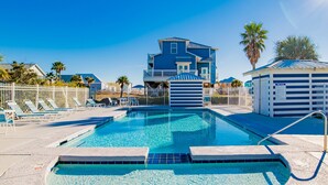 A swimming pool with lounge chairs and a pool house. - Seahawk South B by Southern Vacation Rentals (Gulf Shores)