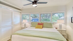 A bedroom with a bed, two bedside tables, a ceiling fan, and a window with blinds. - Homey 1bed/1bath condo The Meadows Pool View (Sarasota)