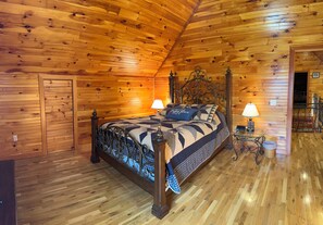 A wooden-paneled bedroom with a four-poster bed, two bedside lamps, and a small table with a lamp. - Marfly Mount Olive Retreat (Melbourne)