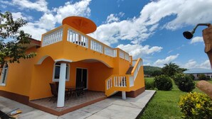 Une maison à deux étages dotée d’un balcon et d’un escalier menant à l’étage supérieur.