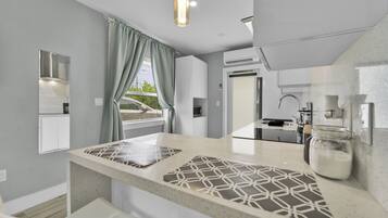 Fridge, microwave, stovetop, coffee/tea maker