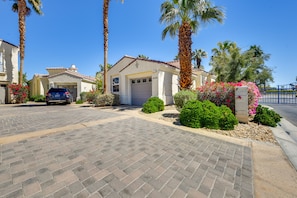 A residential street with two houses, a paved driveway, and palm trees. - Pool & Hot Tub Access: La Quinta Vacation Home (La Quinta)