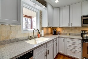 A kitchen with white cabinets, a granite countertop, a stainless steel oven, and a dishwasher. - Smith Mountain Lake Getaway w/ Private Dock! (Moneta)