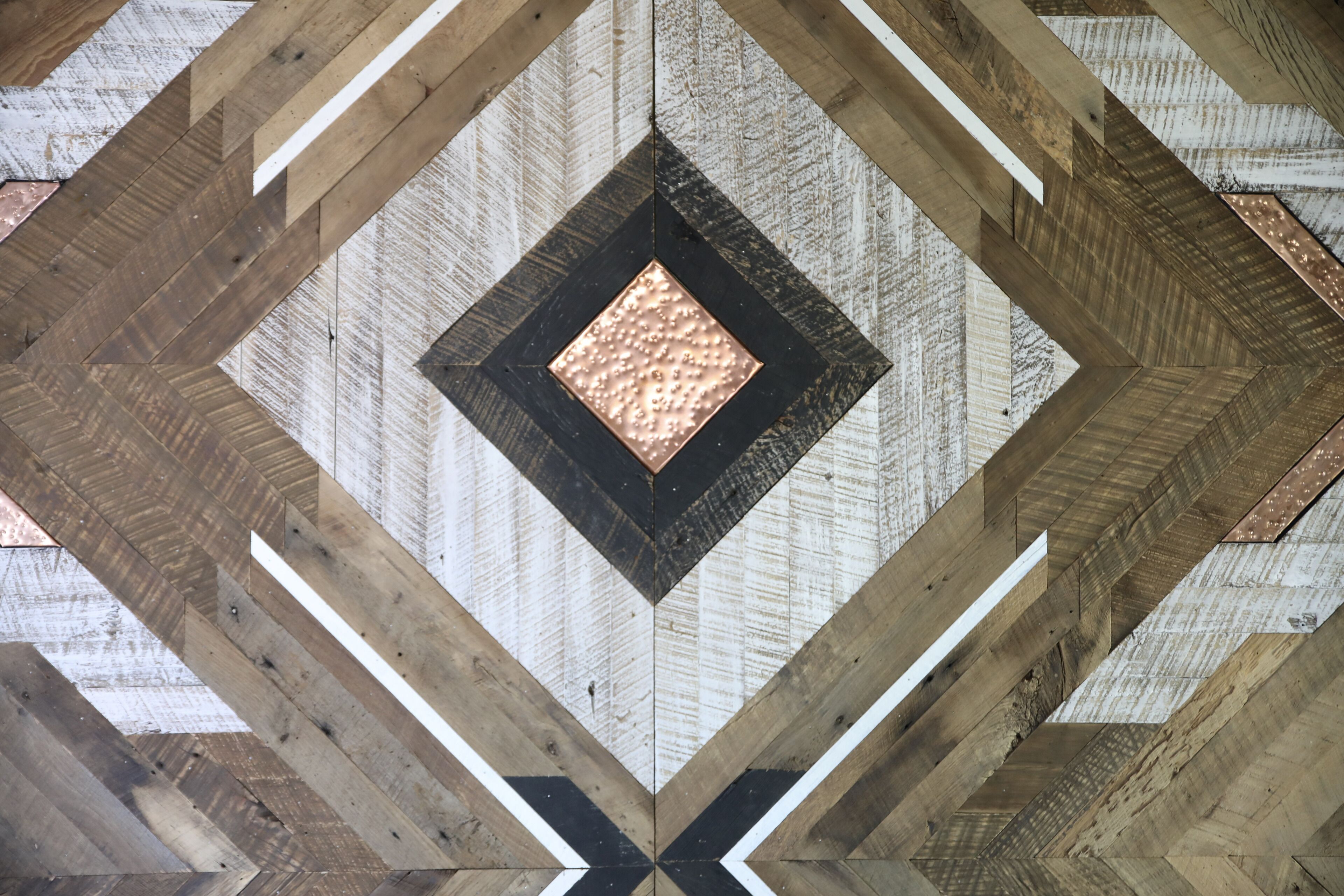 A geometric ceiling design with a central diamond-shaped light fixture.