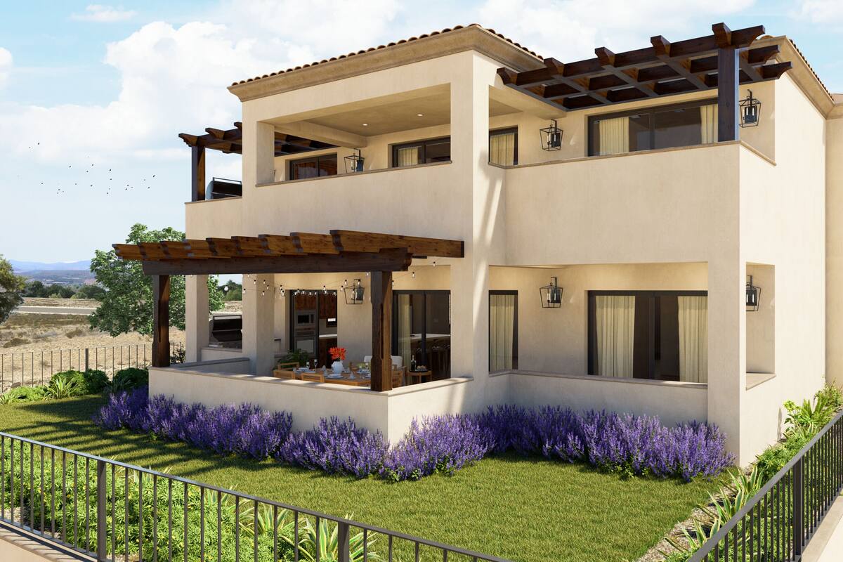 A two-story modern house with a covered patio, a barbecue area, and a view of the surrounding landscape.
