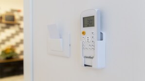Un panel de control montado en la pared con pantalla digital y ranura para tarjetas, probablemente de una máquina de café u otro dispositivo similar.