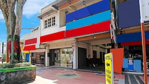 A hotel with a multi-story structure, large windows, and a visible entrance.