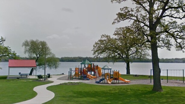 A park with a playground, a covered seating area, and a path leading to a lake. - Lake/Beach Getaway (Remodeled) (Round Lake Beach)