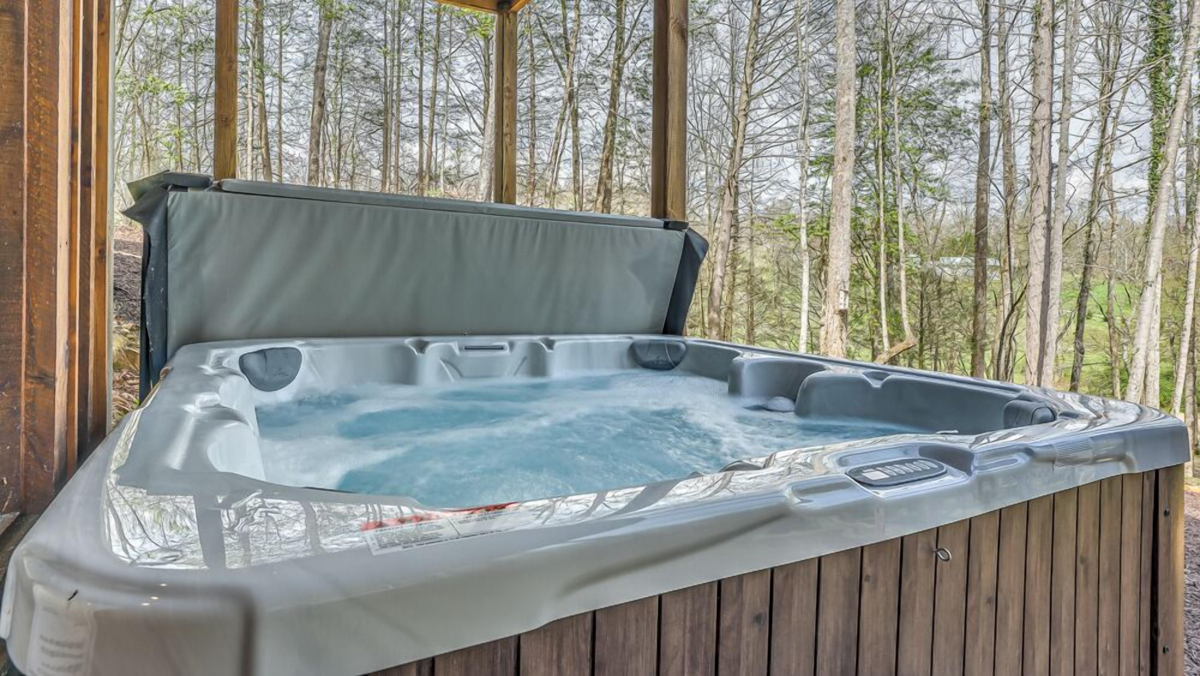 Jacuzzi a terrassa de fusta a l'aire lliure, amb un bosc de fons.
