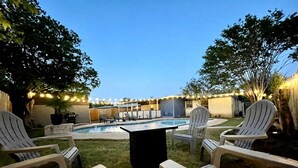 A backyard with a swimming pool, lounge chairs, and string lights. - Trendy&Cute4BR+Pool-NearStMary’sUniversity&DTSA! (San Antonio)