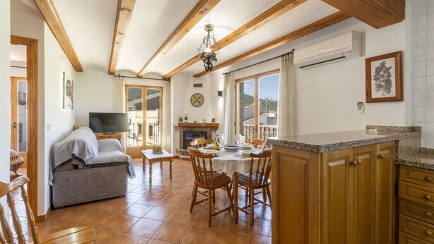 Un'ampia zona giorno con camino, arredamento in legno e tavolo da pranzo.